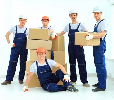 Safe and careful moving team working with furniture protection