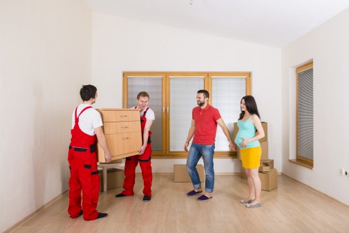 Removal crew transporting packed boxes during a house move